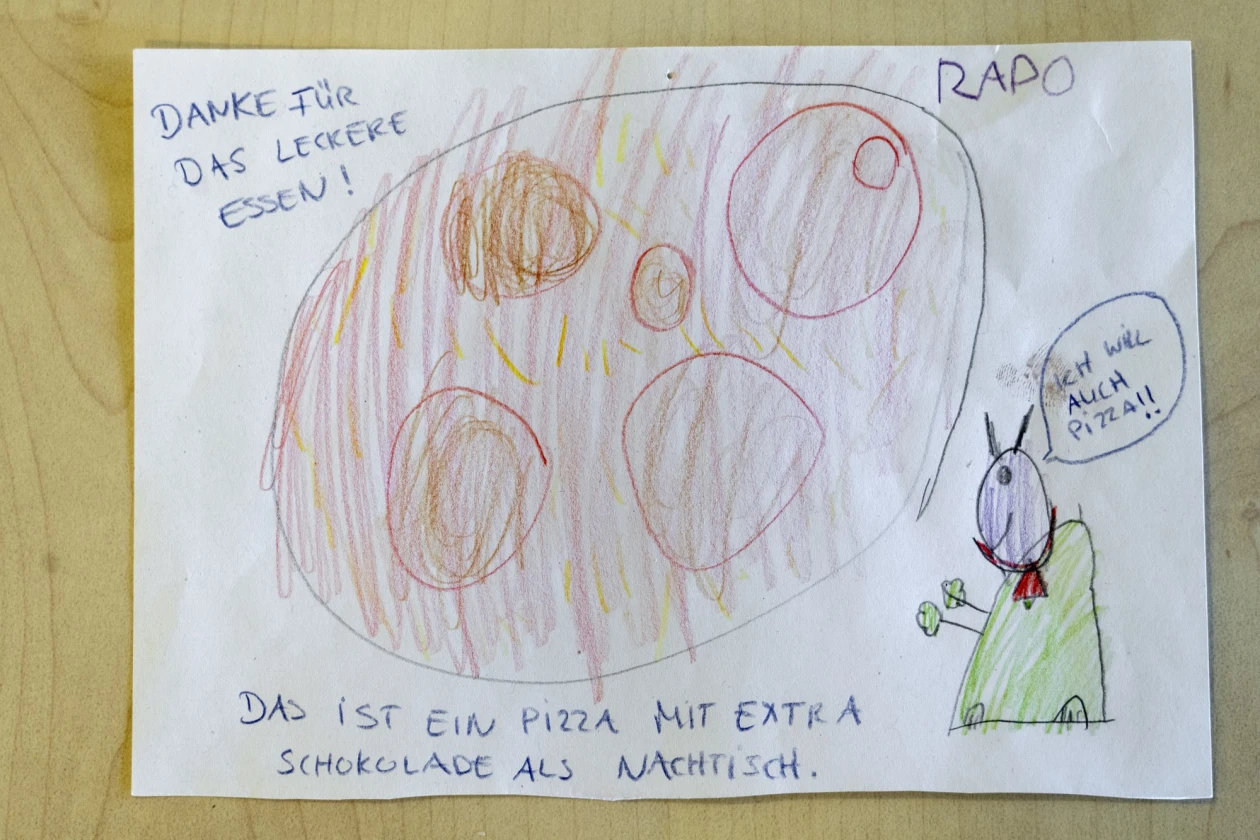 Die Kinderzeichnung zeigt eine Pizza und die Aufschrift "Danke f&uuml;r das leckere Essen!"